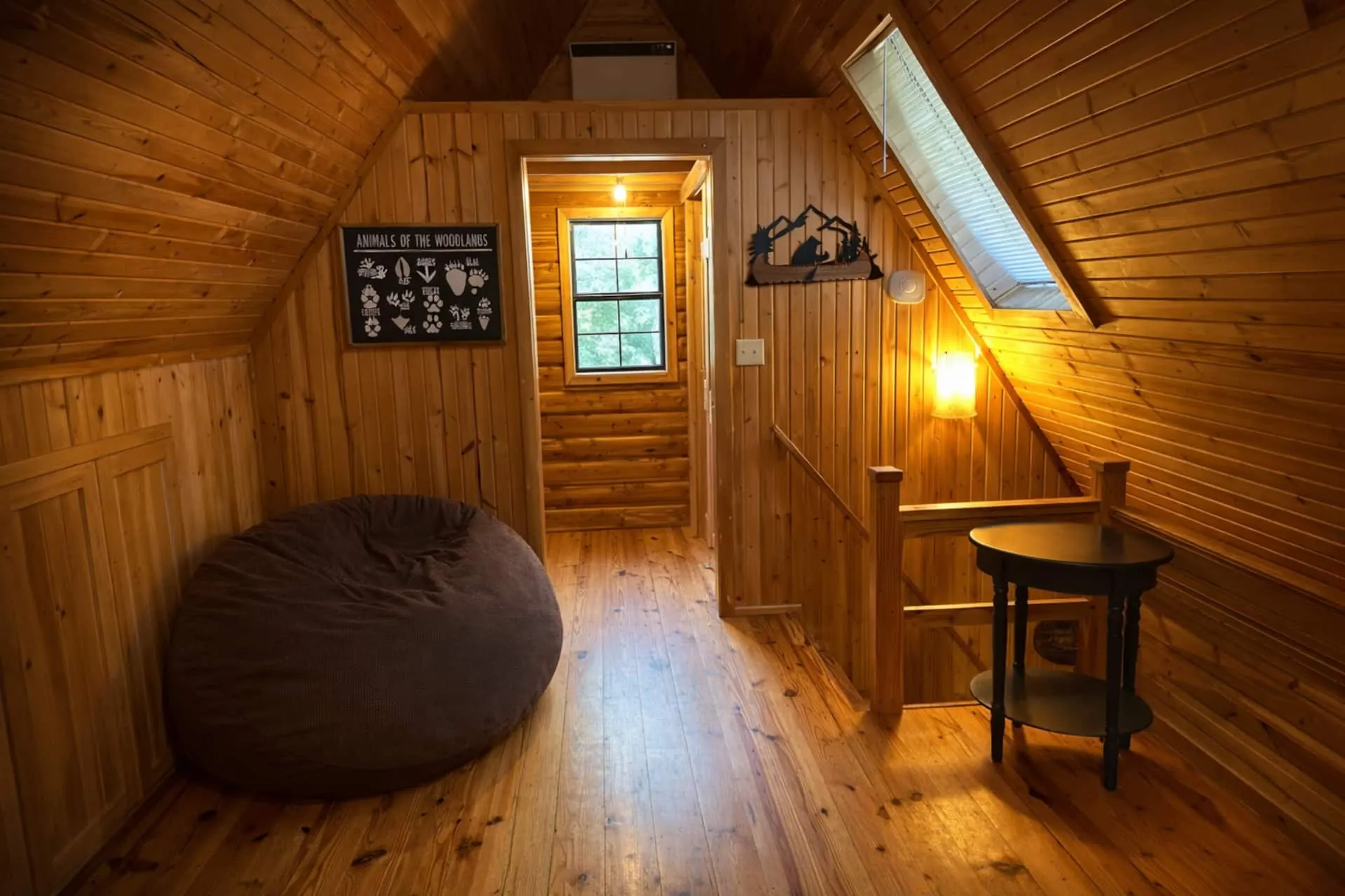 Upstairs landing with the queen Cordaroy convertible bag-chair on pine floors, a skylight above and a small side table
